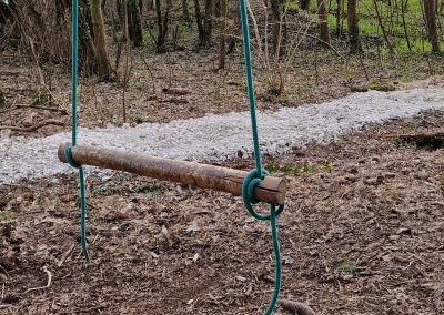 A wood swing in a forest school setting